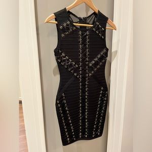 Black mini bodycon dress with black lace and gold grommet details. New with tags